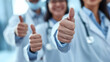 © sornram - Close-up of medical professionals giving thumbs up, signifying approval and confidence in providing quality healthcare services.
