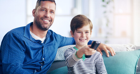 Wall Mural - Were going to be couch potatoes today. Shot of a cheerful father and son relaxing on a couch and spending some time together indoors.