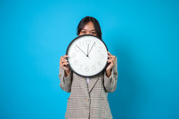 Businesswoman Peeking On Clock Isolated On Blue Background