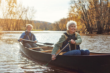 Wall Mural - Lake, rowing and kayak with senior couple, relax and retirement with happiness, weekend break and vacation. Outdoor, river and mature man with old woman, support and trust with holiday and nature