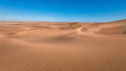 Canvas Print - Serene desert landscape with sand dunes and clear blue sky in Namibia, Africa