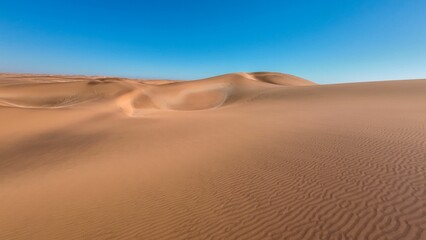 Canvas Print - Serene desert landscape with sand dunes and clear blue sky in Namibia, Africa