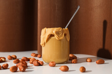 Sticker - Peanut paste in a glass jar, on a dark background.