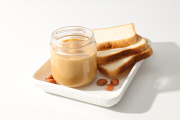 Wall Mural - Peanut paste in a glass jar, on a light background.