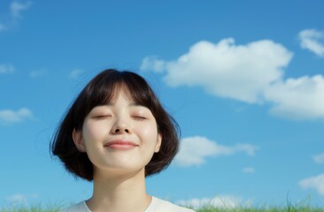 Wall Mural - young woman enjoying nature with eyes closed