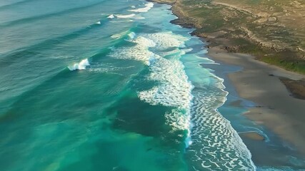 Poster - Waves crash on a black sand beach, creating a stunning contrast of colors. The turquoise water and white foam create a breathtaking scene.