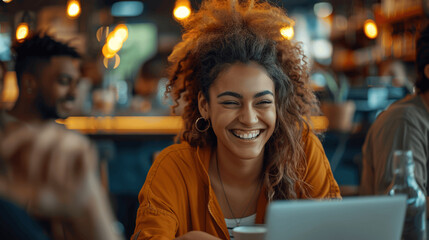 Canvas Print - Young Diverse Group of Professionals Collaborating in a Cafe, Smiling and Enjoying a Casual Team Meeting with Laptops and Cinematic Lighting