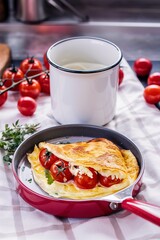 Wall Mural - Omelette with cherry tomatoes