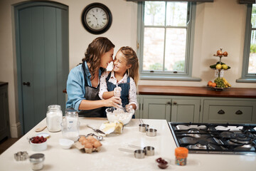 Wall Mural - Baking, mother and girl in kitchen, hug and ingredients with time together, hobby and support. Happy parent, mama or daughter with nutrition, learning and home with embrace, care and recipe with bowl