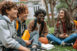 © btiger - Multiracial Students Relaxing and Socializing at Campus College Park with Friends and Books