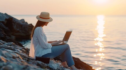 Poster - Digital nomad woman in the hat a business woman with a laptop sits on the rocks by the sea during sunset makes a business transaction online from a distance Freelance remote work on va : Generative AI