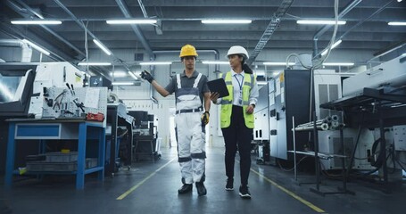 Leinwandbilder - Two Male and a Female Factory Employees Walk Through a High Tech Manufacturing Facility, Discussing Operations and Production Machinery. Diverse Employees Wear Safety Gear and Carry a Tablet Computer