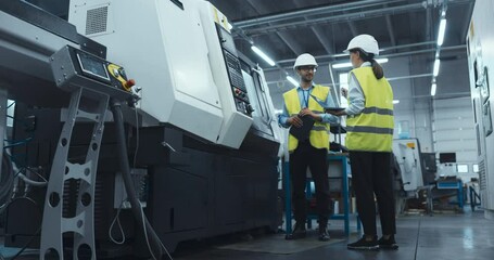 Leinwandbilder - Two Industrial Engineers at Work. Caucasian Female with a Laptop and a Middle Eastern Male Monitor a CNC Machine in a High Tech Metal Factory, Ensuring Precision and Efficiency in Automation Processes
