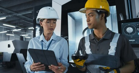 Leinwandbilder - Female Industrial Engineer Having a Conversation with a Young Asian Technician at a Manufacturing Plant. Colleagues Using Tablet Computer, Discussing Specifications of a Produced Metal Part