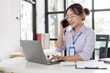 © David - Happy asian business woman call centre representative customer support agent talking to client, smiling asian female working using laptop computer in office.