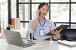 © David - Happy asian business woman call centre representative customer support agent talking to client, smiling asian female working using laptop computer in office.