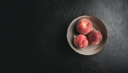 Poster - peach in a bowl on a black background, top view