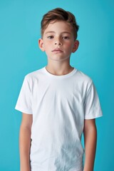 Poster - A young boy posing for a photo wearing a white t-shirt, suitable for use as a stock image in children's clothing or lifestyle photography