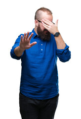 Poster - Young caucasian hipster man wearing glasses over isolated background covering eyes with hands and doing stop gesture with sad and fear expression. Embarrassed and negative concept.