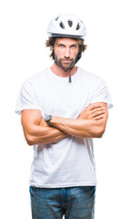 Poster - Handsome hispanic cyclist man wearing safety helmet over isolated background skeptic and nervous, disapproving expression on face with crossed arms. Negative person.