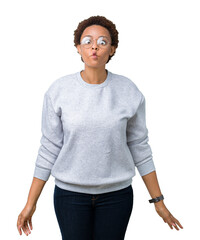 Wall Mural - Young beautiful african american woman wearing glasses over isolated background making fish face with lips, crazy and comical gesture. Funny expression.