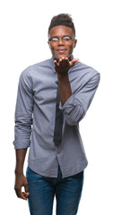 Poster - Young african american business man over isolated background looking at the camera blowing a kiss with hand on air being lovely and sexy. Love expression.