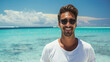 © Cadengo - A fit man stands on a tropical beach, wearing sunglasses and a radiant smile. The clear blue sky and shimmering ocean behind him create a perfect summer vacation scene.