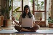 © darshika - Indian woman practices yoga and meditation with remote e coach.