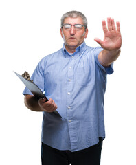 Poster - Handsome senior inspector man holding clipboard over isolated background with open hand doing stop sign with serious and confident expression, defense gesture