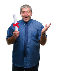 Wall Mural - Handsome senior man holding degree over isolated background very happy and excited, winner expression celebrating victory screaming with big smile and raised hands