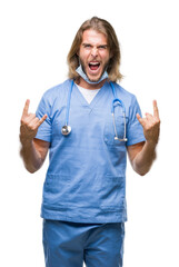 Sticker - Young handsome doctor man with long hair over isolated background shouting with crazy expression doing rock symbol with hands up. Music star. Heavy concept.