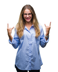 Sticker - Young beautiful blonde business woman wearing glasses over isolated background shouting with crazy expression doing rock symbol with hands up. Music star. Heavy concept.