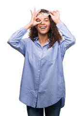 Poster - Beautiful young hispanic woman wearing glasses with happy face smiling doing ok sign with hand on eye looking through fingers