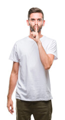 Sticker - Young handsome man over isolated background asking to be quiet with finger on lips. Silence and secret concept.