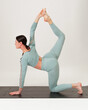 © Cavan - Young woman practicing  asana on white background studio.