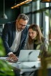 © MYDAYcontent - Office Colleagues Reviewing Laptop