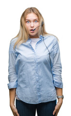 Poster - Young caucasian business woman wearing call center headset over isolated background afraid and shocked with surprise expression, fear and excited face.