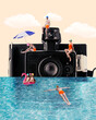 © Lustre Art Group  - Contemporary art collage. Capturing joy of summer, friends lounge and play around giant camera, turning every splash into timeless moment of happiness. Concept of retro summer, surrealism, holidays