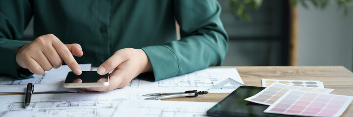 Fototapete - Architects interior designer hands working with Blue prints and documents for a home renovation for house design