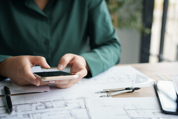 Fototapete - Architects interior designer hands working with Blue prints and documents for a home renovation for house design