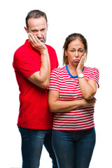 Sticker - Middle age hispanic couple in love over isolated background thinking looking tired and bored with depression problems with crossed arms.