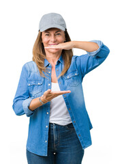 Poster - Beautiful middle age woman wearing sport cap over isolated background gesturing with hands showing big and large size sign, measure symbol. Smiling looking at the camera. Measuring concept.