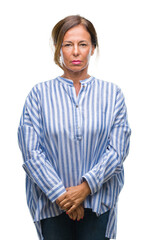 Wall Mural - middle age senior hispanic woman over isolated background with serious expression on face. simple an