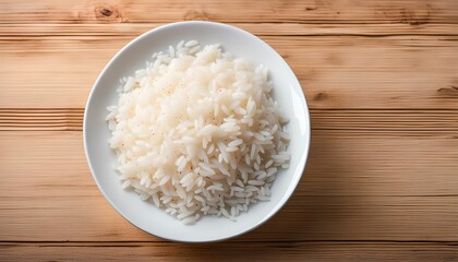 Homemade cooked rice in white bowl on wooden table as background.