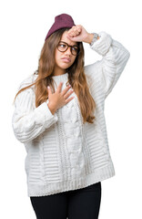 Canvas Print - Young beautiful brunette hipster woman wearing glasses and winter hat over isolated background Touching forehead for illness and fever, flu and cold, virus sick