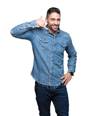 Canvas Print - Young handsome man over isolated background smiling doing phone gesture with hand and fingers like talking on the telephone. Communicating concepts.