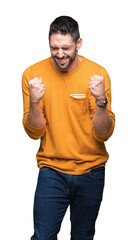 Sticker - Young handsome man over isolated background very happy and excited doing winner gesture with arms raised, smiling and screaming for success. Celebration concept.