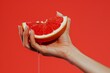 © ArtSpree - Female hand close-up crushes grapefruit on a black background. Studio isolated background.. Beautiful simple AI generated image in 4K, unique.