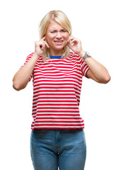 Wall Mural - Young beautiful blonde woman over isolated background covering ears with fingers with annoyed expression for the noise of loud music. Deaf concept.