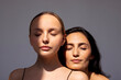 © Dasha Petrenko - Beauty portrait of two attractive young women with clean healthy skin and hair. Charming models with natural makeup on a gray isolated background. Cosmetology and spa treatments. Skin care concept.